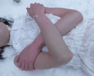 A woman shivering in a white dress in the snow [Image video-style work]